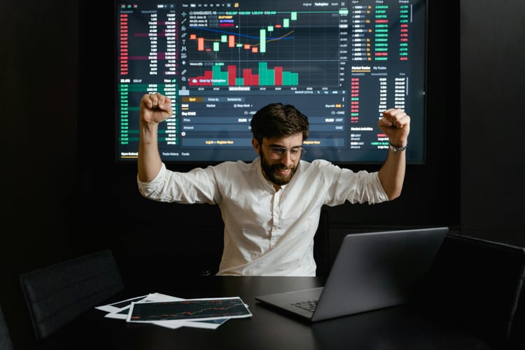 office room with man excited about trading